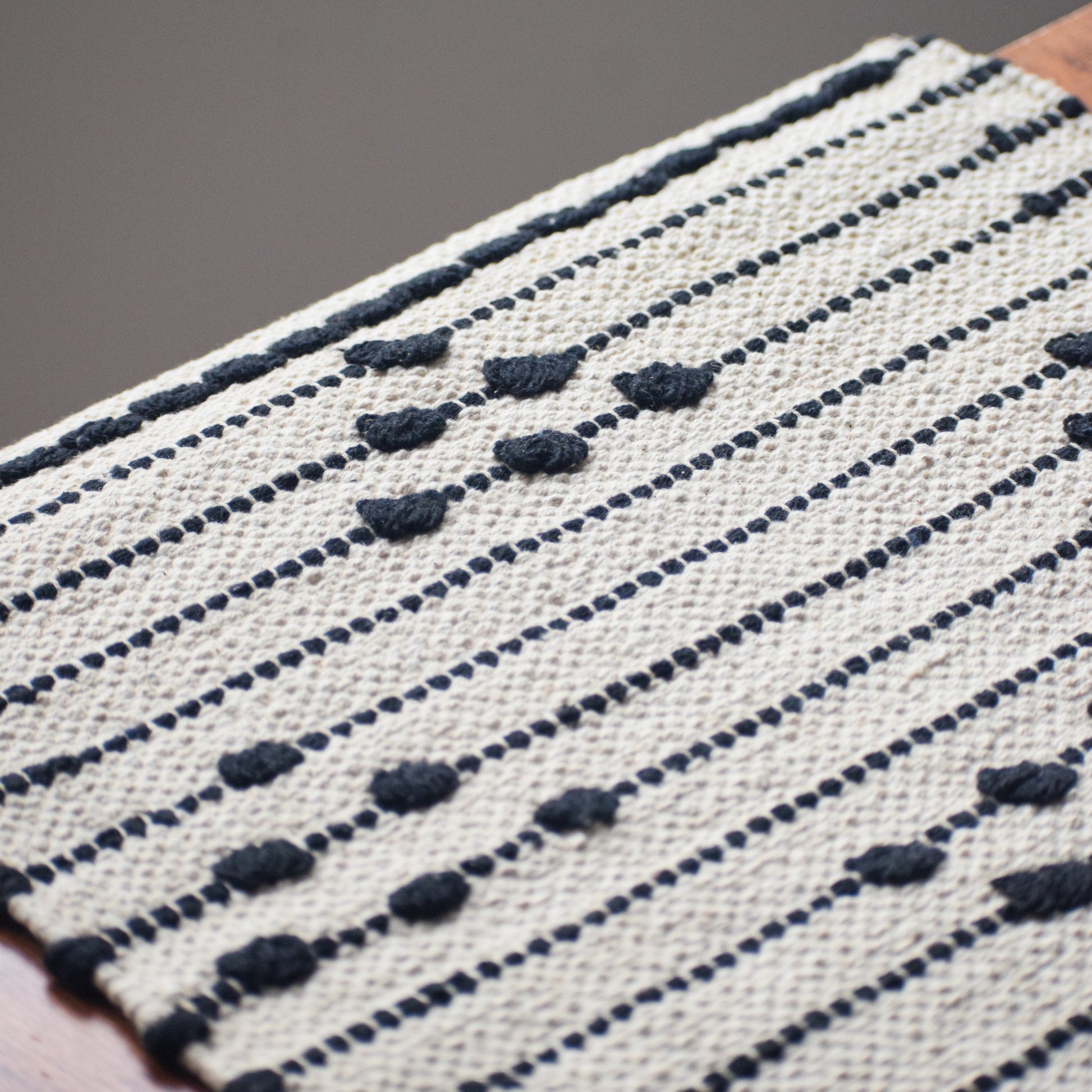 Textile with black and white pattern on a wooden surface