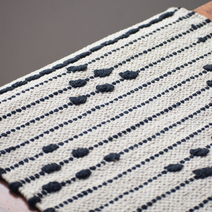 Textile with black and white pattern on a wooden surface