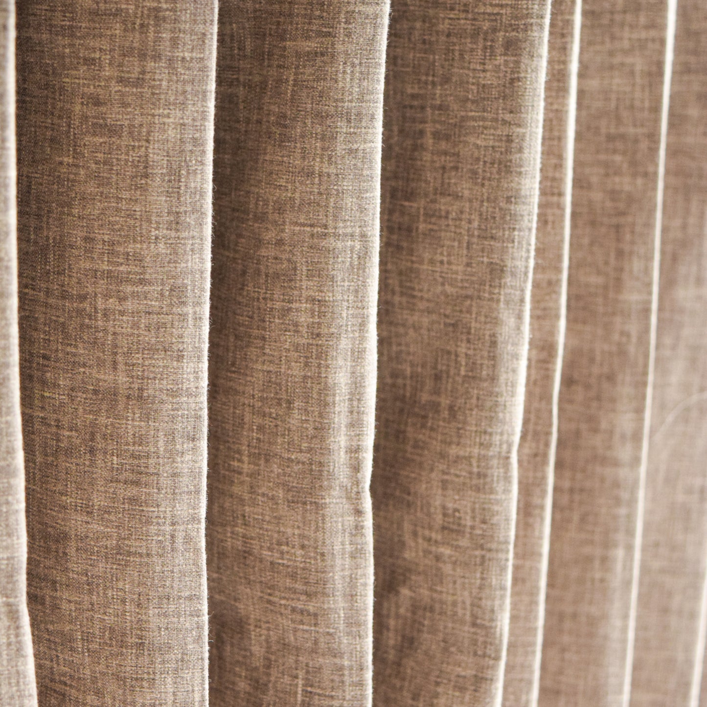 Close-up of brown textured fabric with vertical pleats