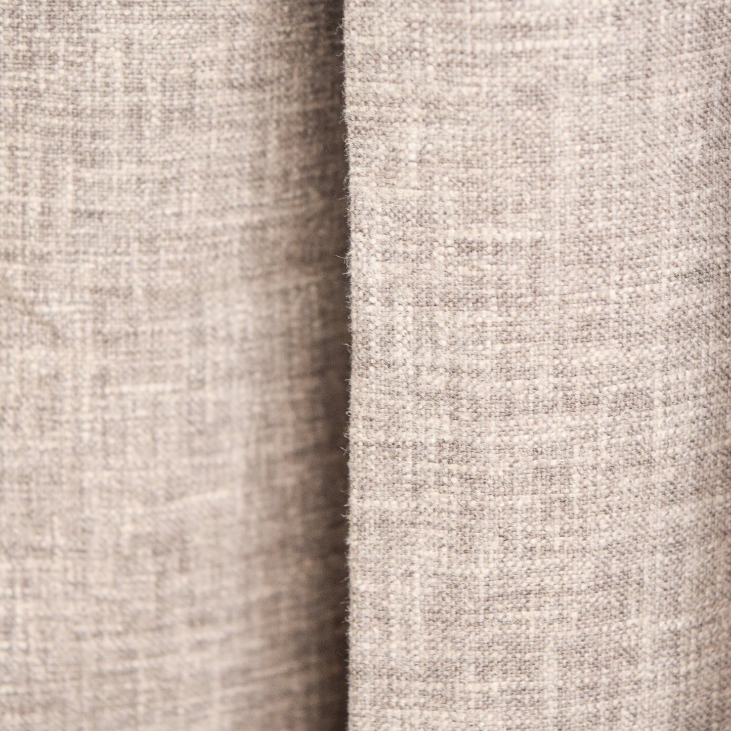 Close-up of a textured beige fabric with a subtle pattern