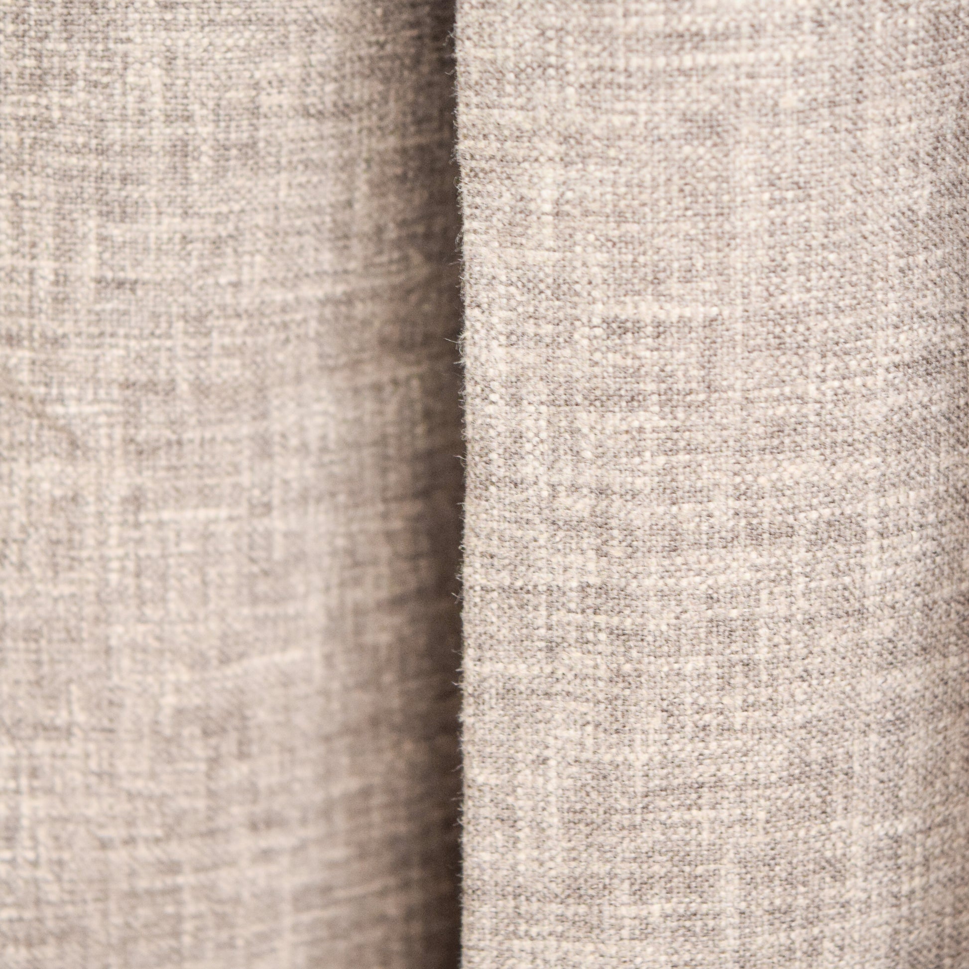 Close-up of a textured beige fabric with a subtle pattern