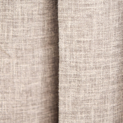 Close-up of a textured beige fabric with a subtle pattern