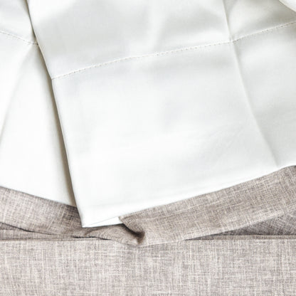 Close-up of white fabric sheets on a textured gray surface