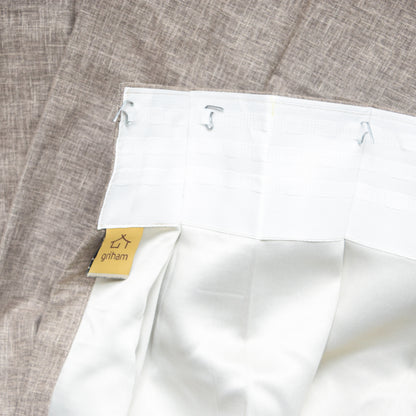 White fabric with a Griham label on a textured gray background