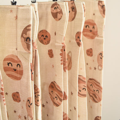 Textile with planet pattern hanging on a rack
