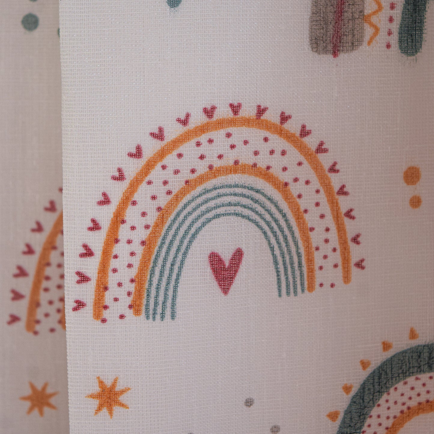 Fabric with rainbow and heart pattern on a beige background