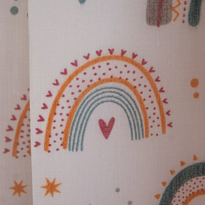 Fabric with rainbow and heart pattern on a beige background