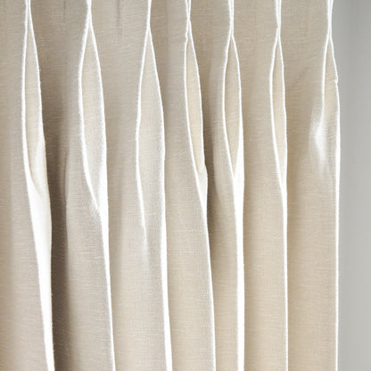Beige curtain with wavy pattern on a white background