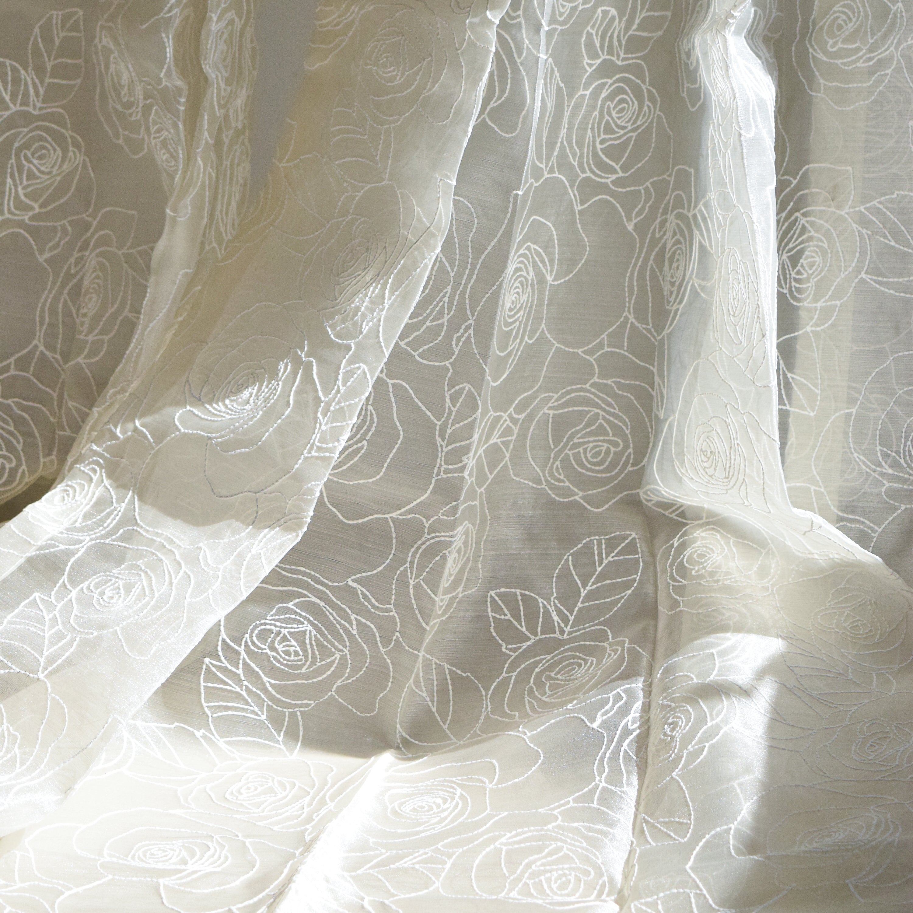 White curtain fabric with subtle rose pattern