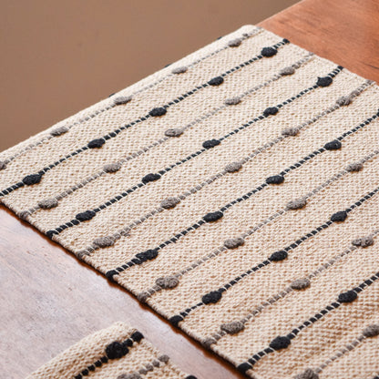 Textured rug with black and gray pattern on a wooden floor