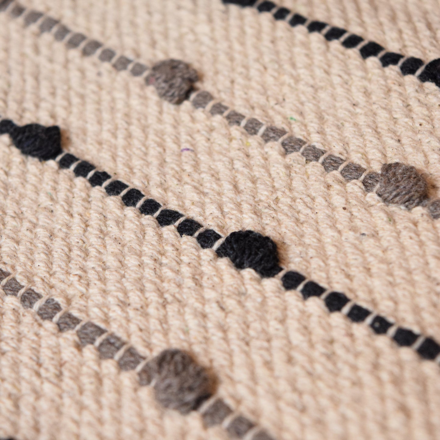 Close-up of a textured fabric with black and gray patterns