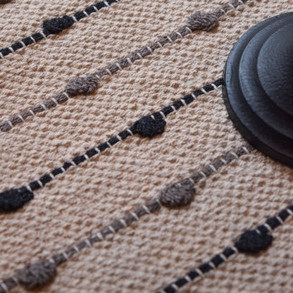 Close-up of a textured rug with black and gray patterns