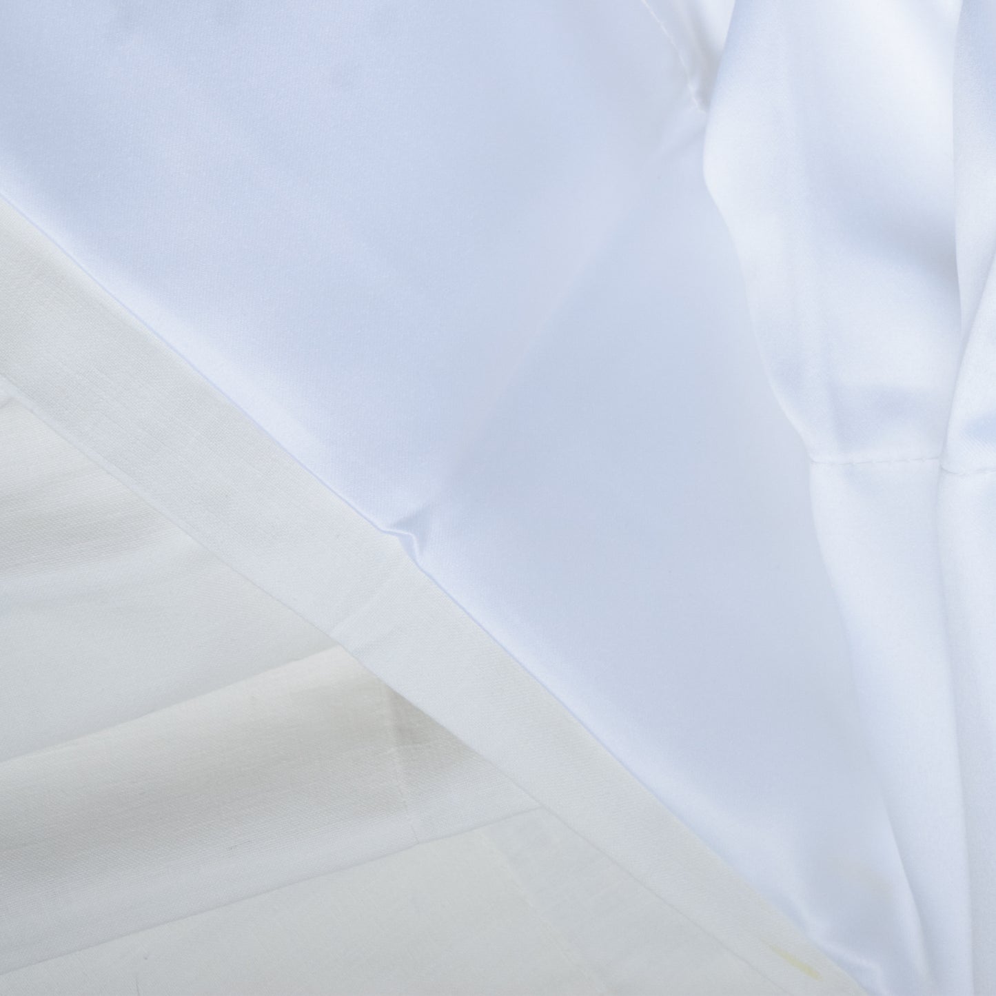 Close-up of white fabric with light blue background