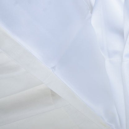 Close-up of white fabric with light blue background
